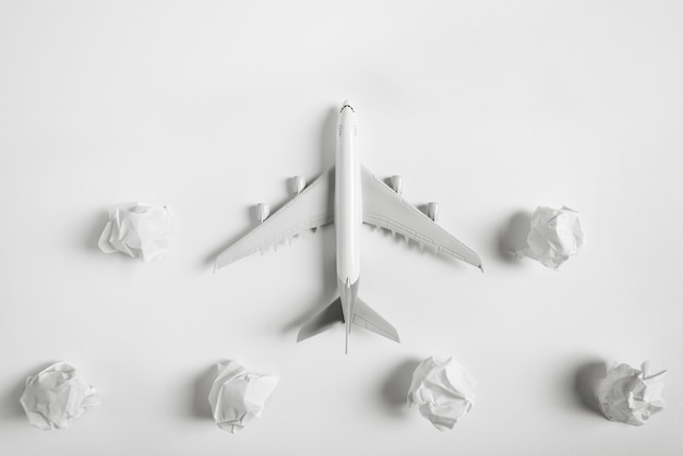 Airplane model flying among paper clouds