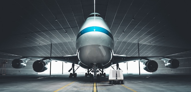 Airplane parking in a hanger inside airport . Elements of this image furnished by NASA