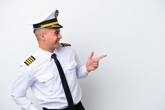 Airplane pilot caucasian man isolated on white background pointing finger to the side and presenting a product