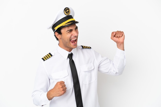 Airplane pilot over isolated white background celebrating a victory