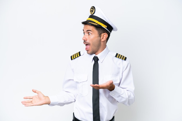 Airplane pilot over isolated white background with surprise facial expression