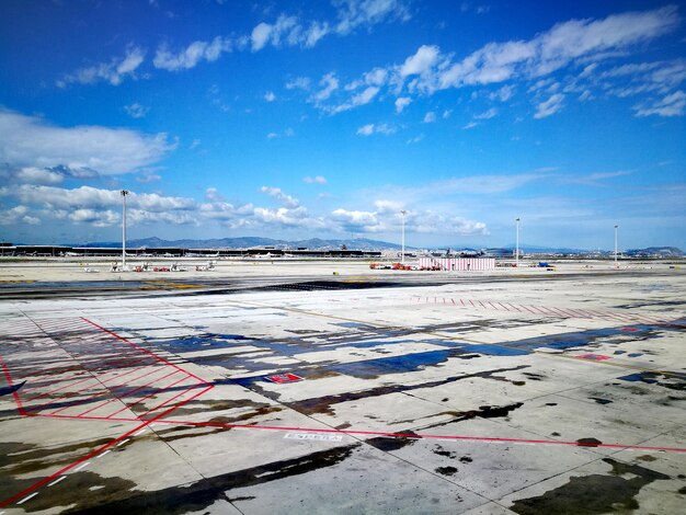 Airplane on runway against sky