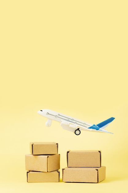 Airplane and stack of cardboard boxes. concept of air cargo and parcels, airmail. fast delivery of goods and products. cargo aircraft