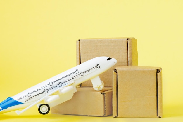 Airplane and stack of cardboard boxes. concept of air cargo and parcels, airmail. Fast delivery of goods and products. Cargo aircraft