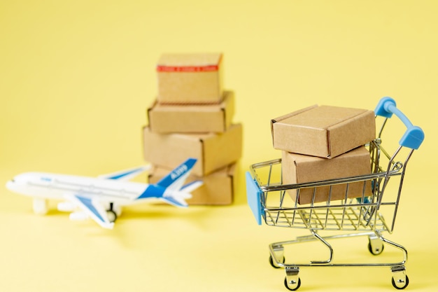 Airplane and stack of cardboard boxes. concept of air cargo and parcels, airmail. Fast delivery of goods and products. Cargo aircraft.