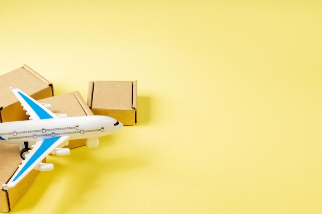 Airplane and stack of cardboard boxes. concept of air cargo and parcels, airmail. fast delivery of goods and products. cargo aircraft