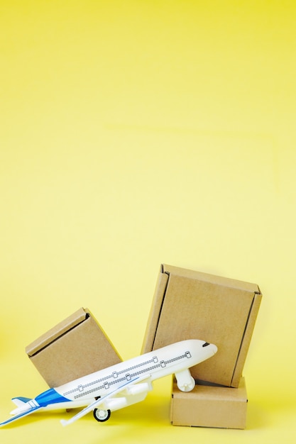 Airplane and stack of cardboard boxes. concept of air cargo and parcels, airmail.