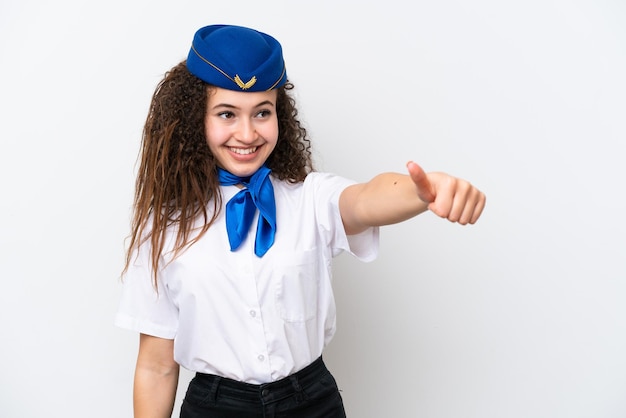Airplane stewardess Arab woman isolated on white background giving a thumbs up gesture