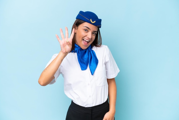 Airplane stewardess caucasian woman isolated on blue background\
happy and counting four with fingers