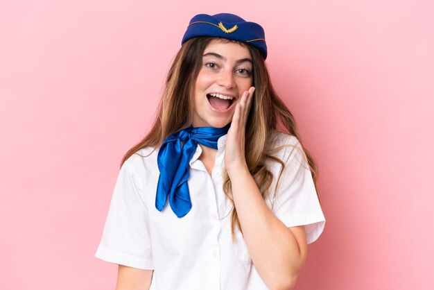 Airplane stewardess caucasian woman isolated on pink background with surprise and shocked facial expression