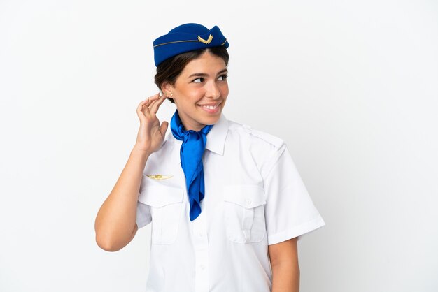 Airplane stewardess caucasian woman isolated on white background thinking an idea