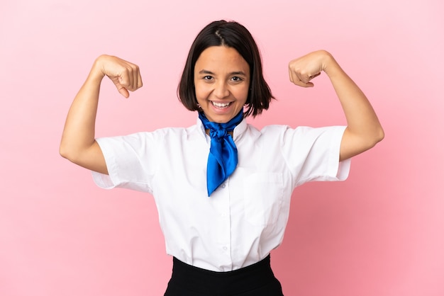 Airplane stewardess over isolated background doing strong gesture