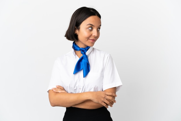 Airplane stewardess over isolated background laughing