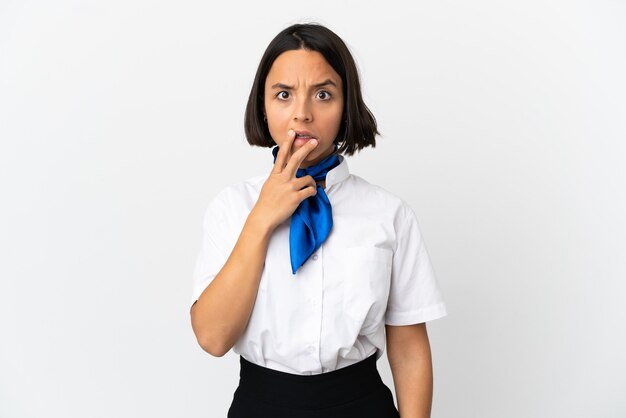 Airplane stewardess over isolated background surprised and shocked while looking right