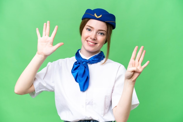 Airplane stewardess over isolated chroma key background counting nine with fingers