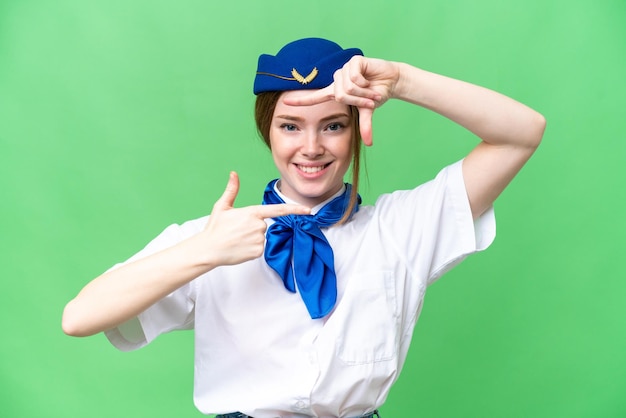 Airplane stewardess over isolated chroma key background focusing face Framing symbol
