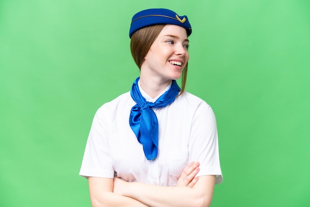 Airplane stewardess over isolated chroma key background happy and smiling