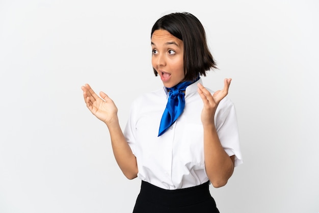 Airplane stewardess over isolated wall with surprise facial expression