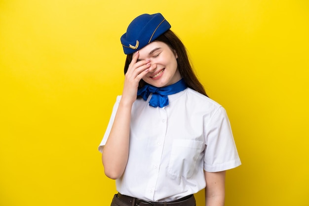 Airplane stewardess Russian woman isolated on yellow background laughing