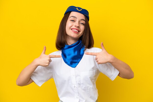 Airplane stewardess ukrainian woman isolated on yellow background proud and selfsatisfied