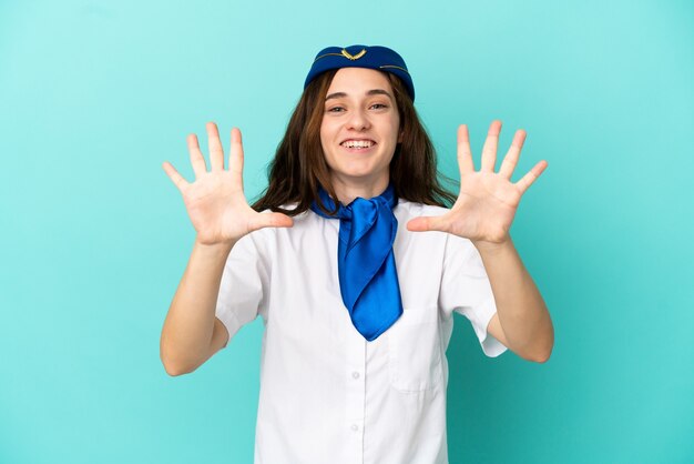 Airplane stewardess woman isolated on blue background counting ten with fingers