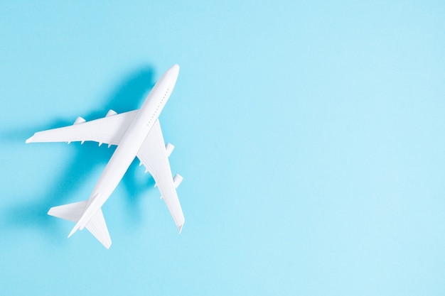 Airplane toy on blue background. Flat lay top view