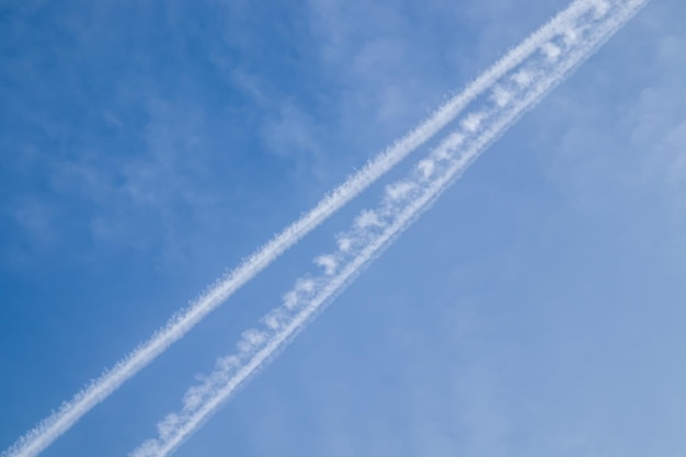 曇った青空と飛行機の軌跡