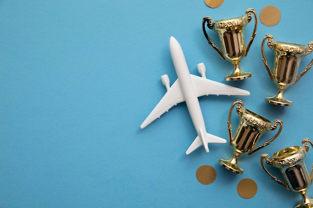 Airplane travel awards. aviation business satisfaction. toy\
airplane with gold trophy.