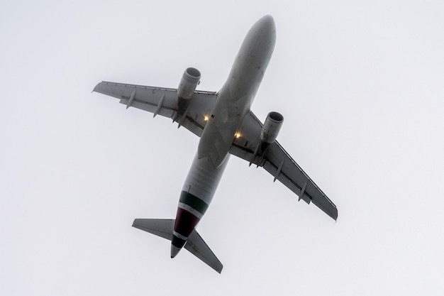 Airplane turning before landing isolated on white