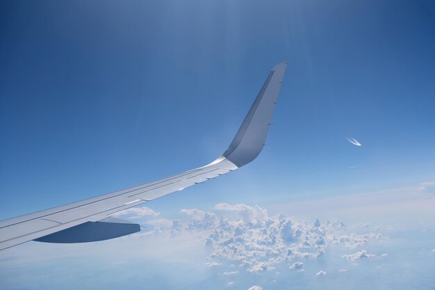 Airplane wing against blue sky