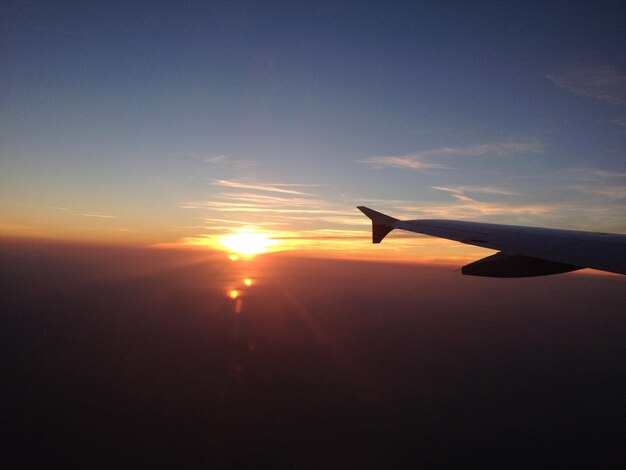 写真 夕暮れの空に向かって飛行機の翼