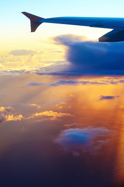 Airplane wing on the setting of the sunset sky
