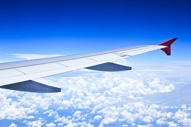 Airplane wings in the blue clouds.