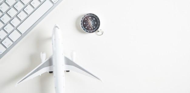 Airplane with computer keyboard and compass. Booking Online