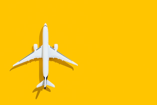 Airplane on a yellow background travel and flights