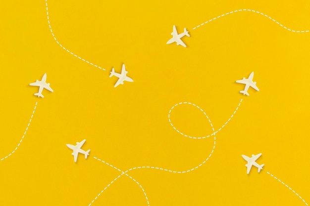 Airplanes on a yellow background. Top view. Flat lay.