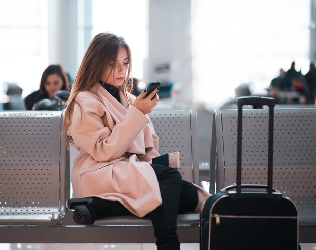 Airport business woman waiting in terminal.