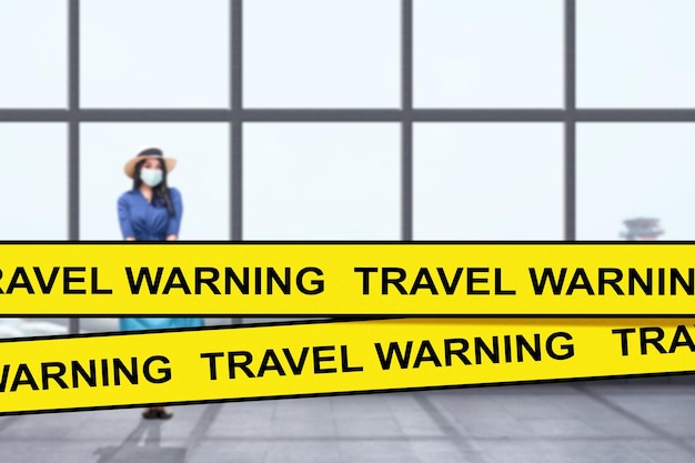 Airport covered with travel warning tape due new variant of covid 19 omicron. Travel Warning concept