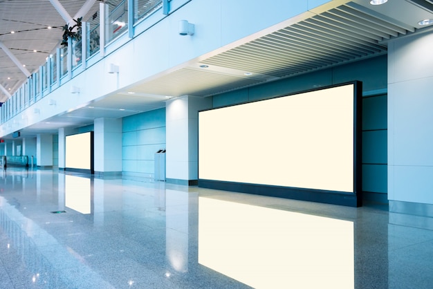 Photo airport passengers and blank billboard