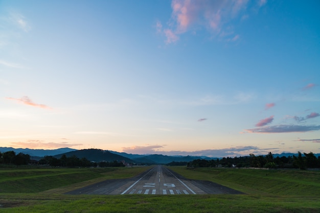 Airport runway sunset.