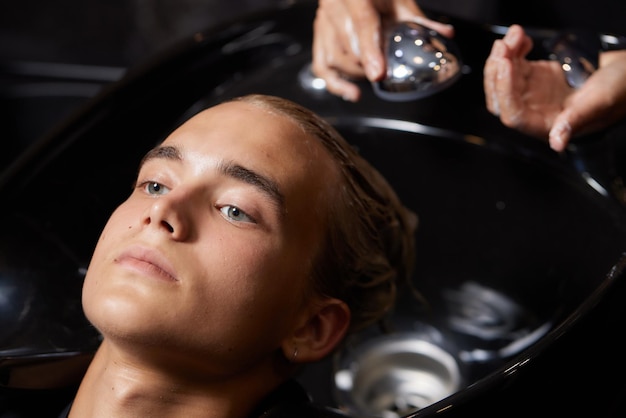 Airtouch Hair stylist makes bouffant using comb on thin strands Shatush technique for hair lightening