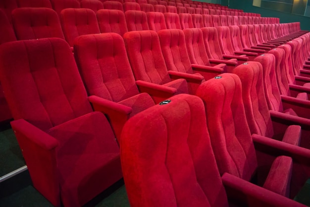 Aisle with rows of red seats in the modern theater