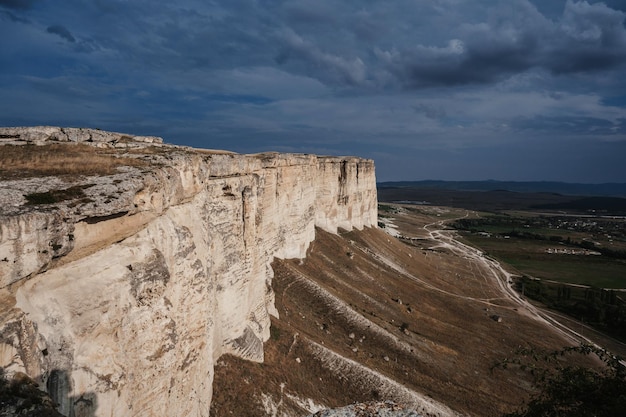 AkKaya or White Rock in Crimea is a rocky limestone plateau in summer under a cloudy sky