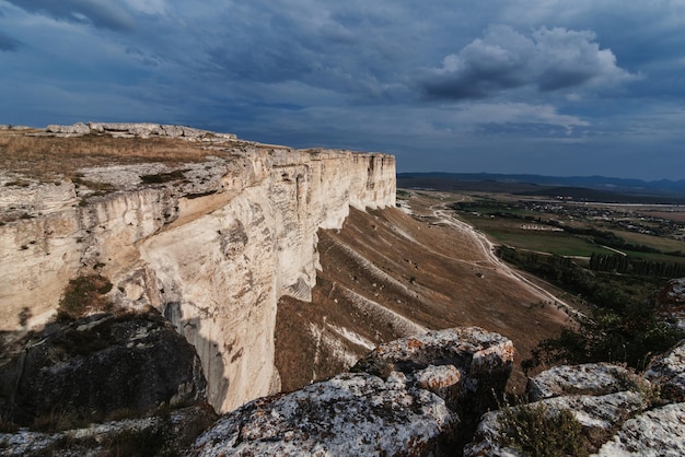 AkKaya or White Rock in Crimea is a rocky limestone plateau in summer under a cloudy sky