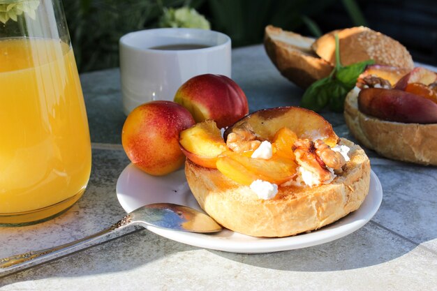 Al fresco Breakfast of grilled bread rolls with goat fat, fruit, nuts, orange juice and coffee