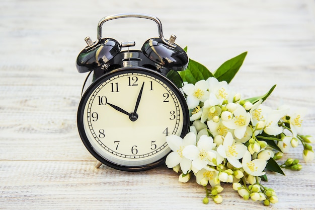 Alarm clock 10 hours. Flowers. Selective focus.