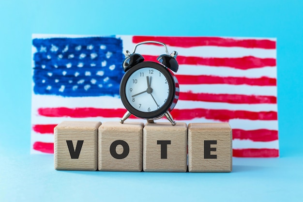 Alarm clock and abstract hand drawn American flag on blue