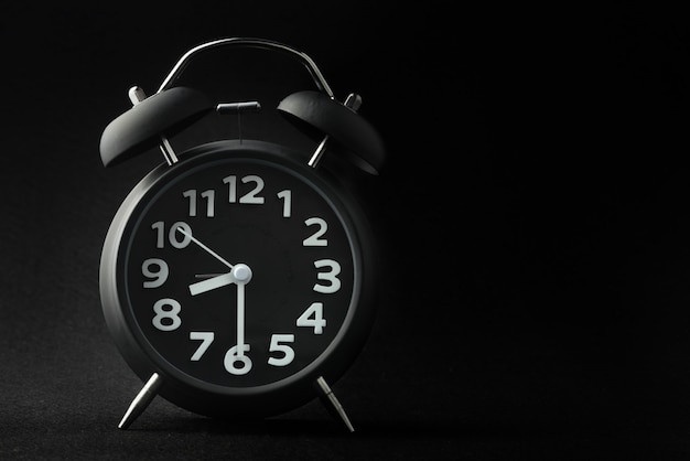 Alarm clock on black background