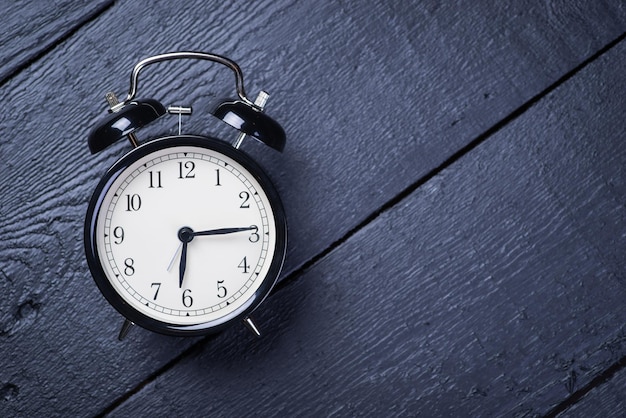 Alarm clock on a black wooden surface