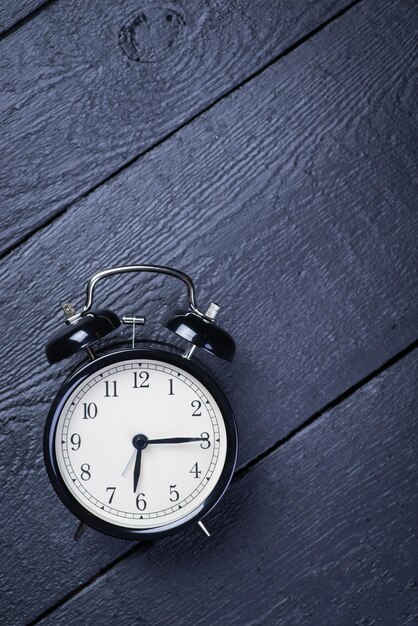 Alarm clock on a black wooden surface